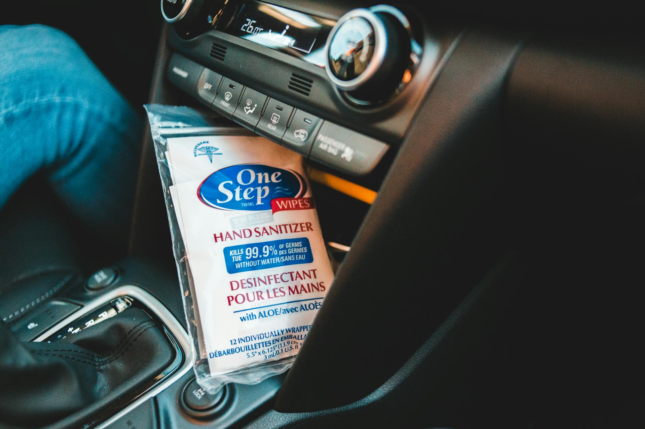 Close-up of car interior with hand sanitizer wipes, highlighting cleanliness and safety.